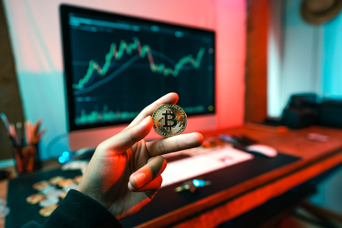 Cryptocurrency a person holding a coin in front of a computer