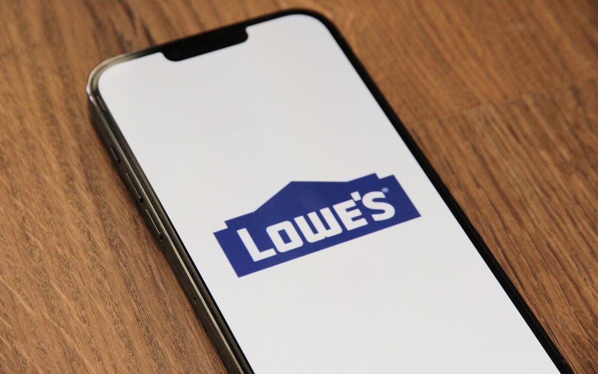 Lowe’s a phone with a logo on it sitting on a table