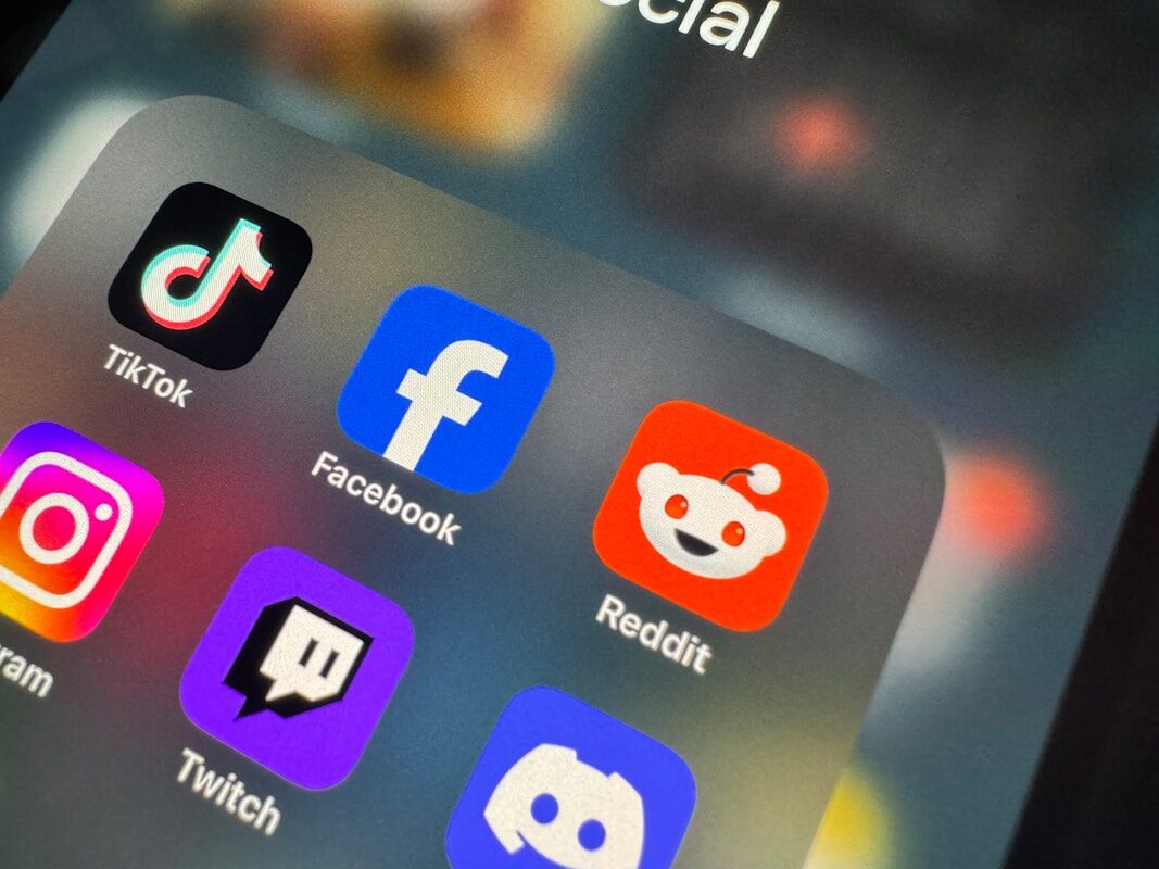 a close up of a cell phone with social icons on it