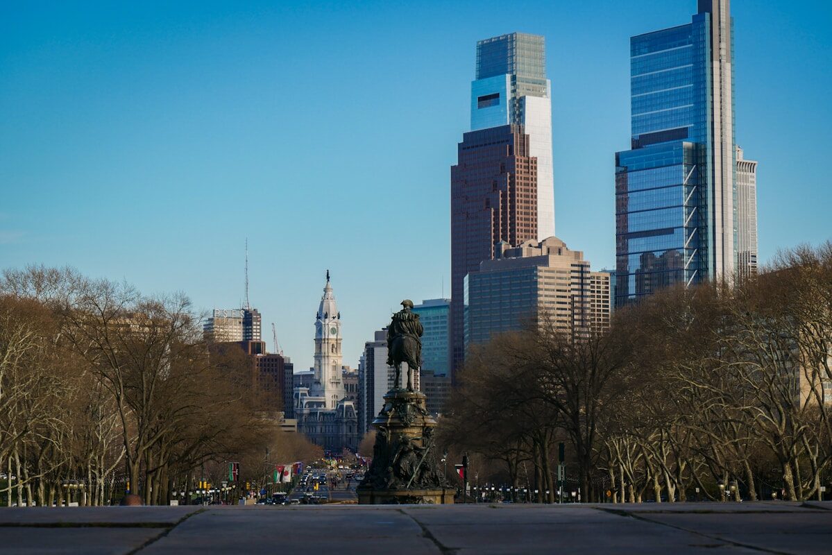 Comcast a city with tall buildings and a statue in the middle