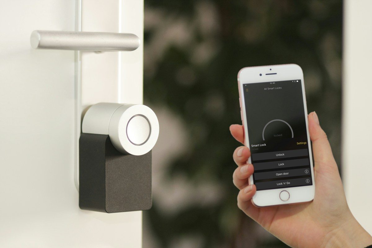 Home Security gold Apple iPhone smartphone held at the door